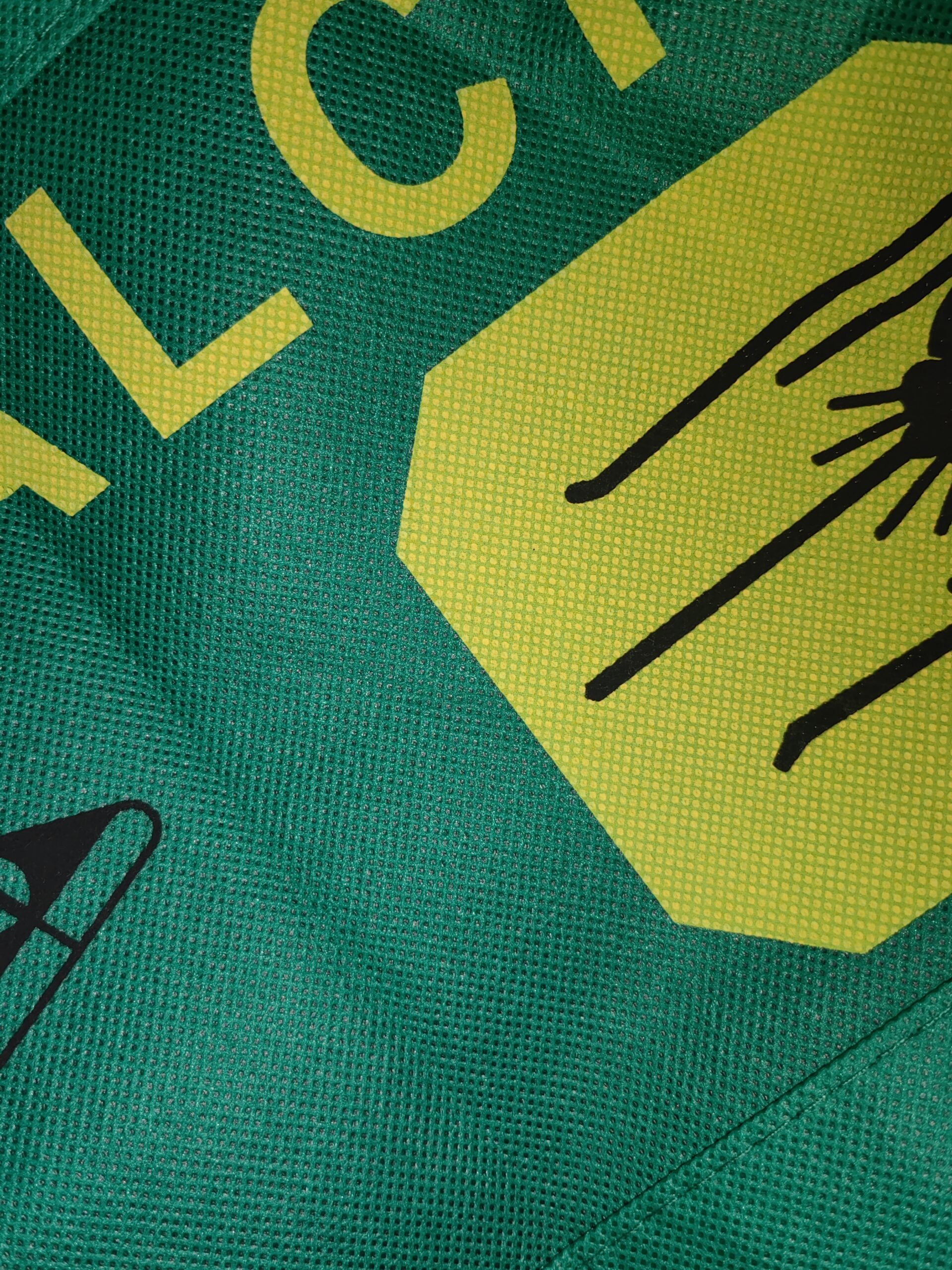 Close-up of green non-woven bag with custom printed design