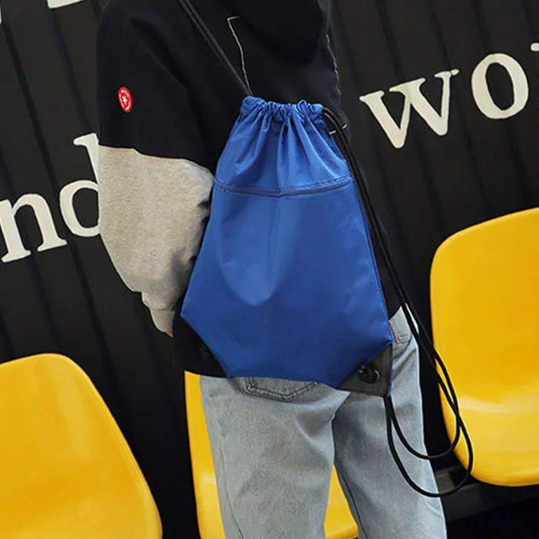 Blue drawstring non-woven backpack on a person