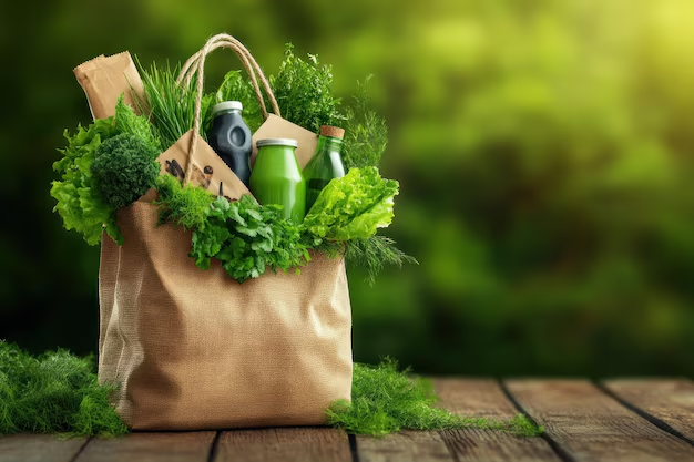 Eco-friendly jute bag filled with fresh vegetables, herbs, and bottled drinks