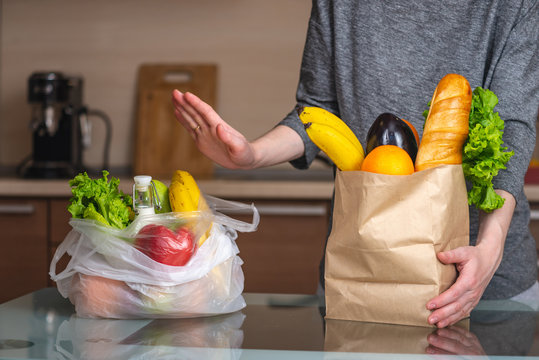 Comparison of plastic bag and paper bag with groceries on a table