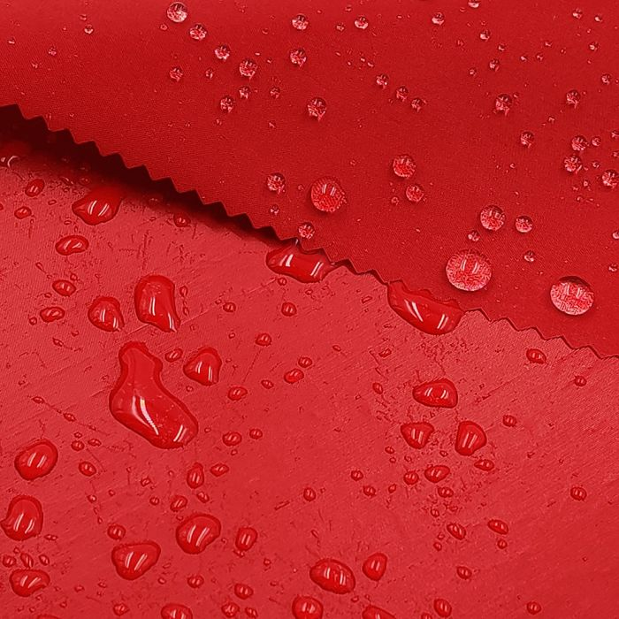 Water droplets on red waterproof fabric