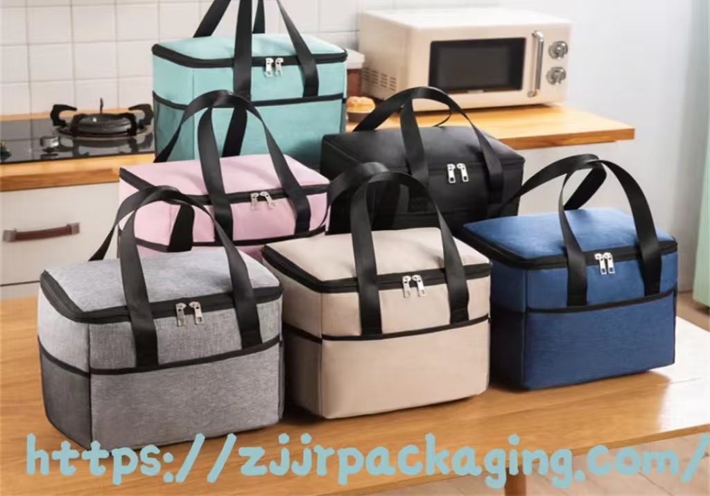 Variety of insulated lunch bags in different colors on a kitchen counter