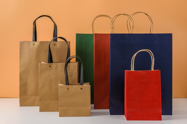 Colorful paper shopping bags with handles in various sizes