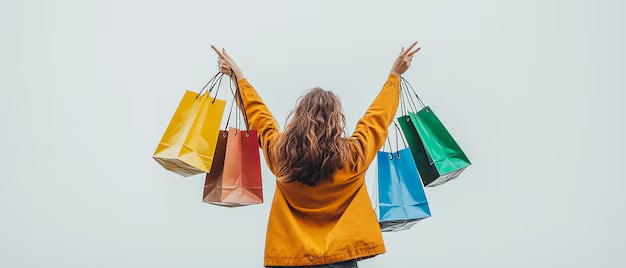 A woman holding colorful shopping bags with raised arms, promoting shopping excitement