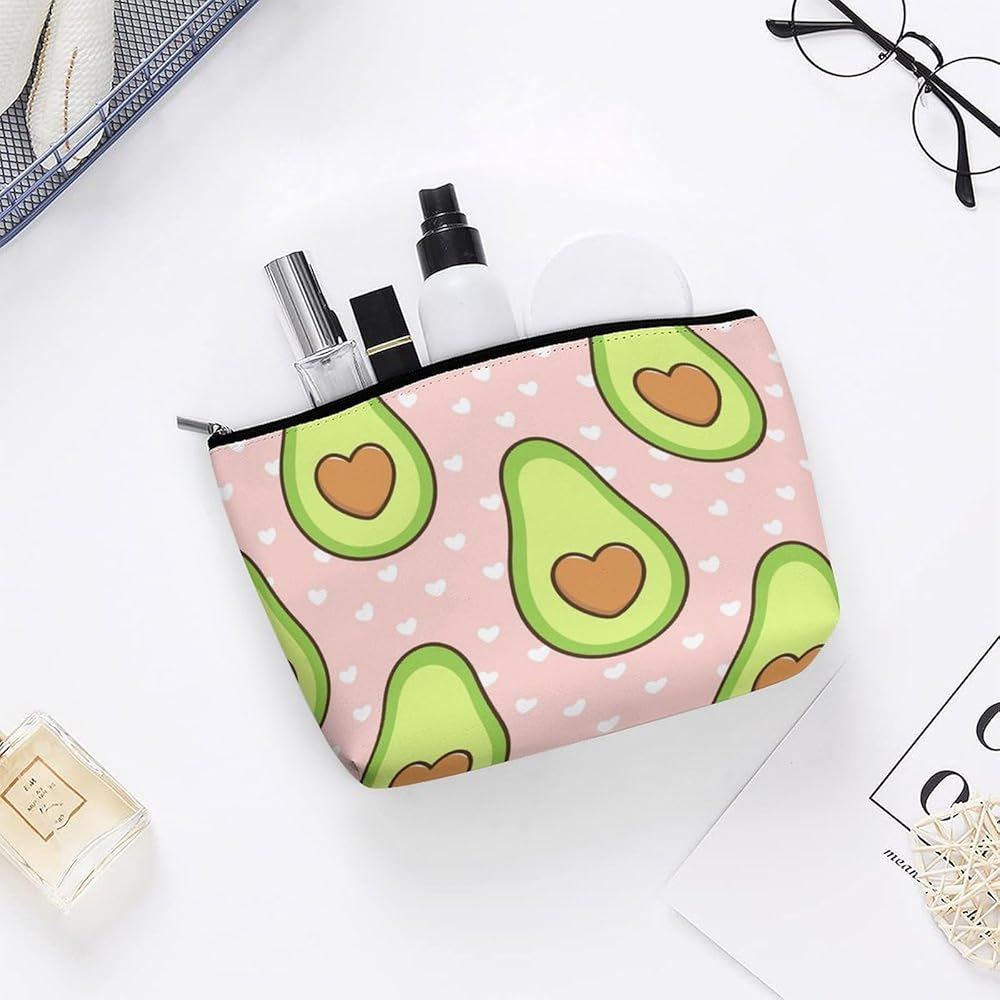 Pink makeup bag with avocado print, holding cosmetic products