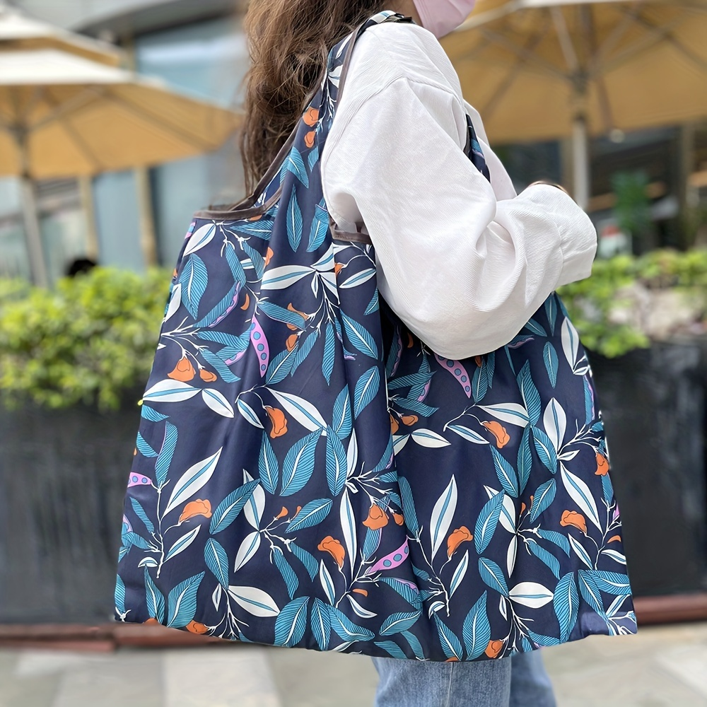 Woman carrying a reusable shopping bag with a colorful floral pattern