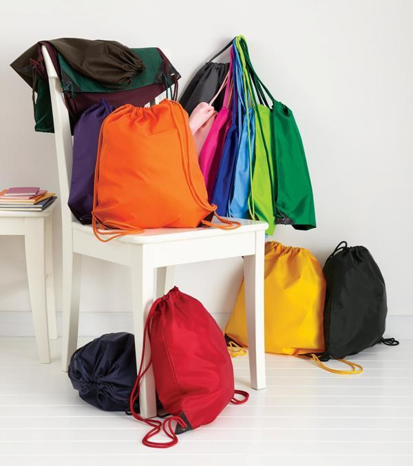 Colorful drawstring bags in multiple colors, neatly displayed on a chair