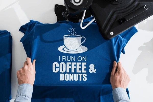 Blue t-shirt with "I run on coffee & donuts" printed on it
