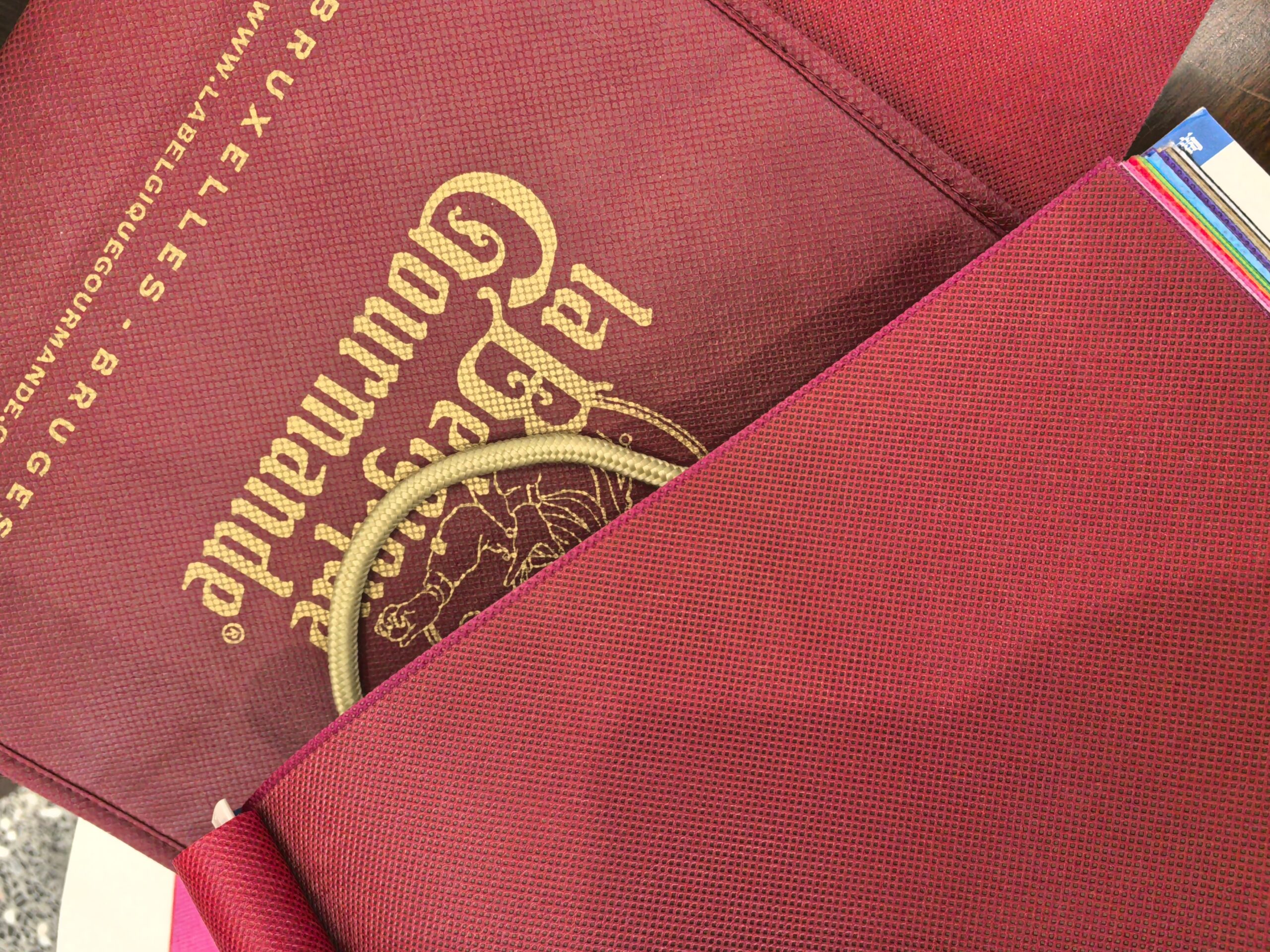 Red custom non-woven bags with gold print for Belgian brand