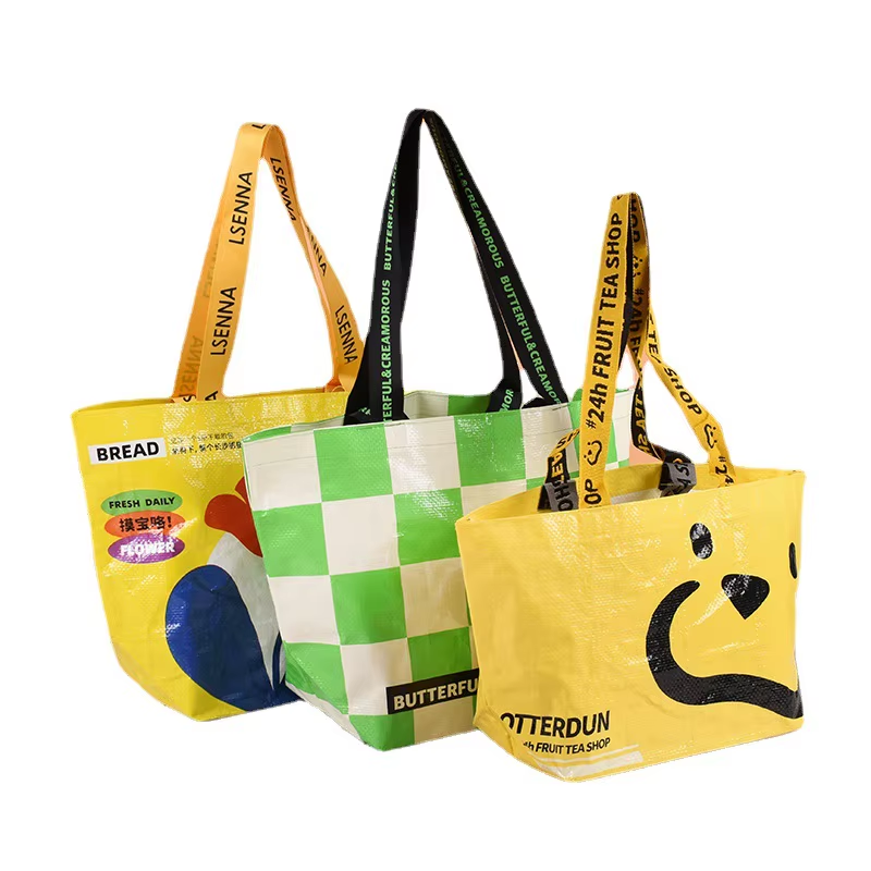 Colorful PP woven bags with bold graphic prints and slogans