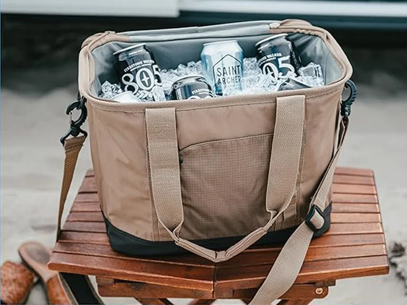 brown insulated cooler bag filled with ice and canned drinks