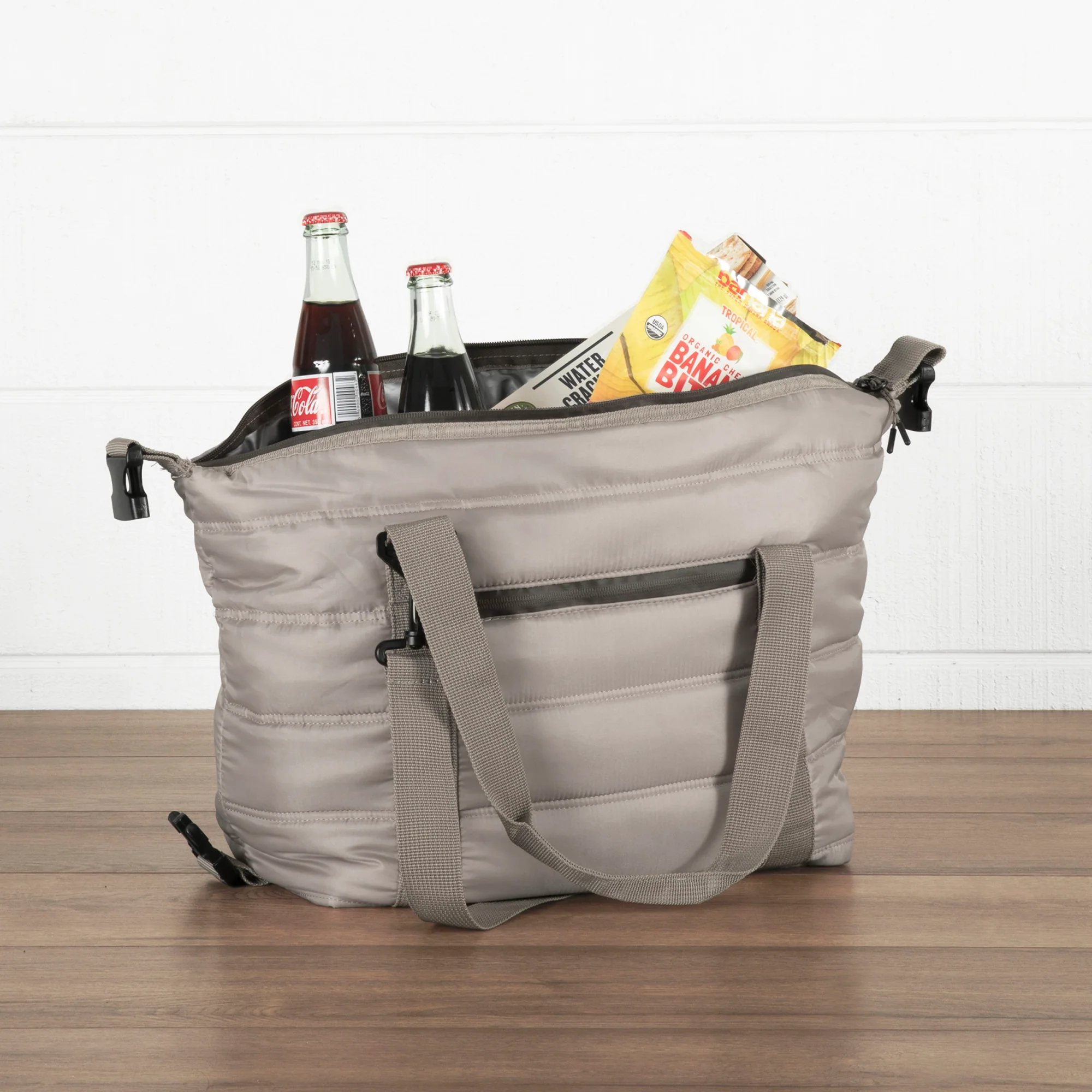 grey insulated cooler bag filled with Coca-Cola bottles and snacks