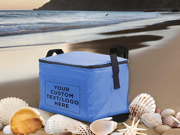 Blue custom insulated cooler bag on beach with seashells