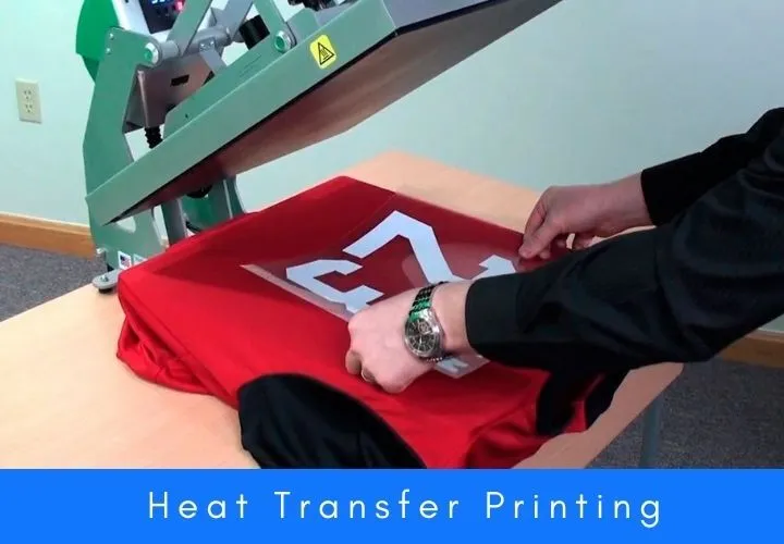 Worker using heat transfer printing machine on red fabric