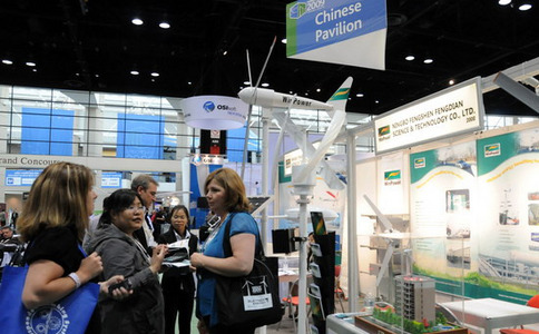 Visitors entering international trade show with staff assisting at gates
