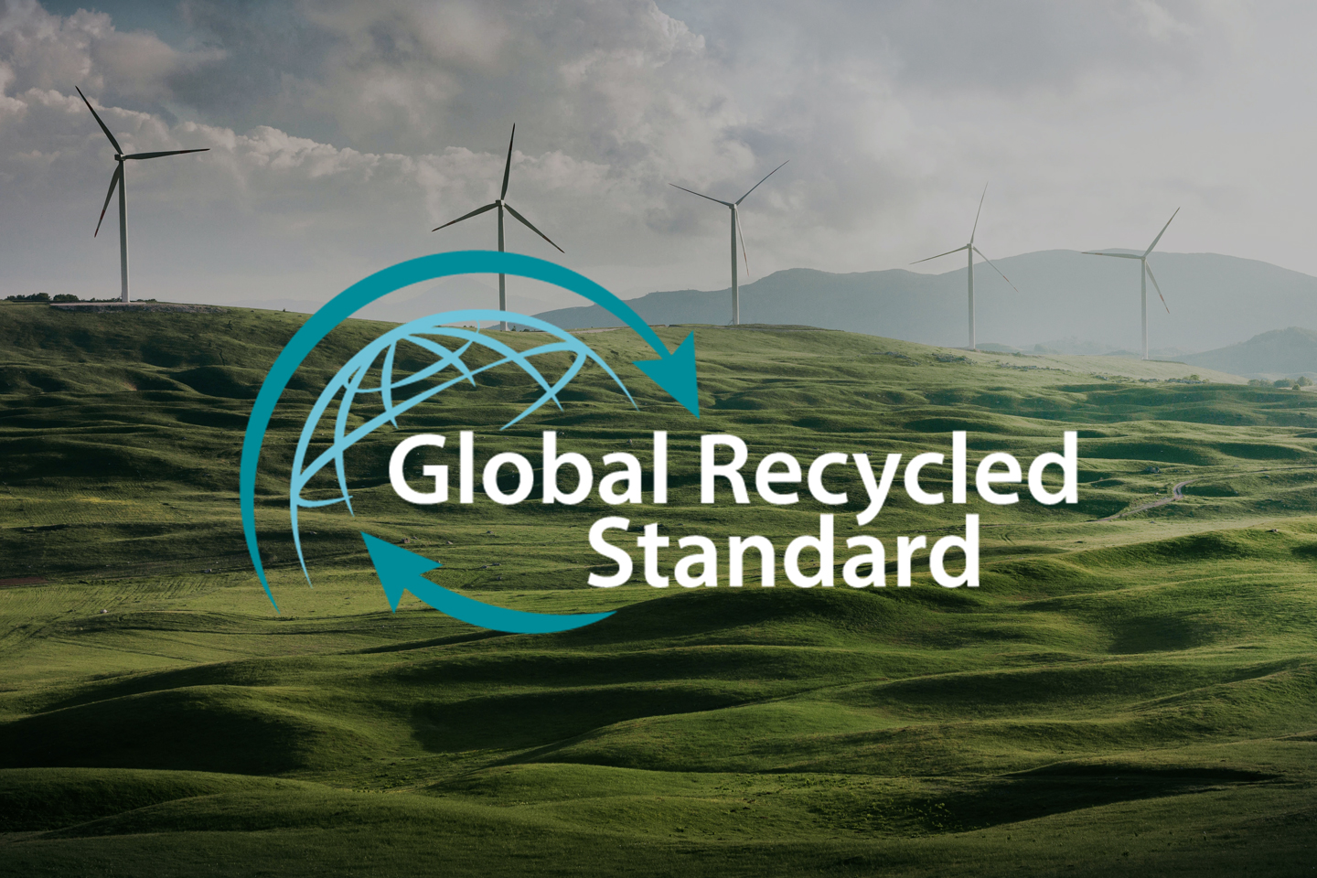 Global Recycled Standard logo over green hills with wind turbines