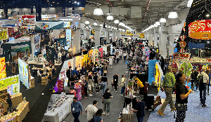 Busy trade show with colorful booths and crowds of visitors