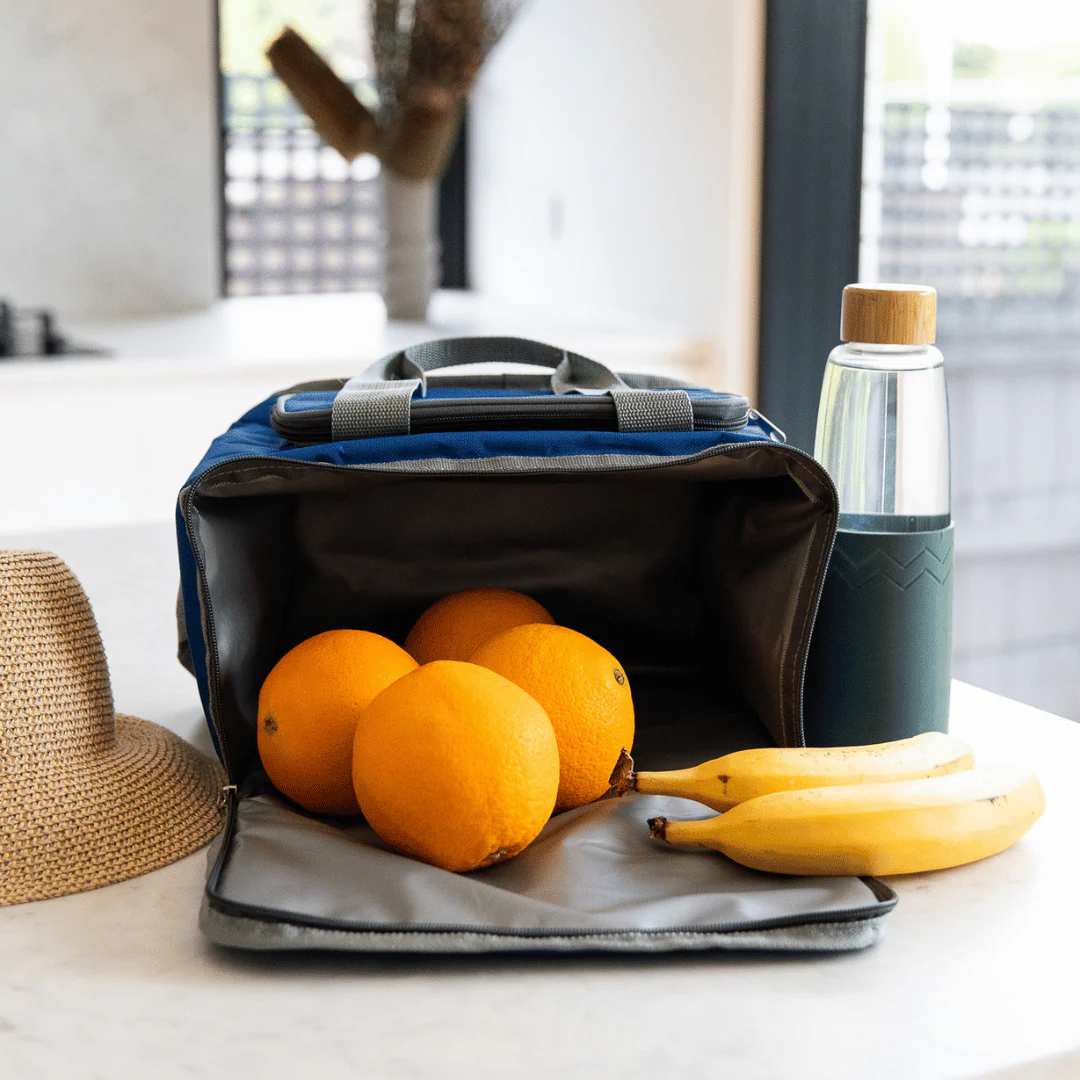 Insulated lunch bag with oranges and bananas on a kitchen counter