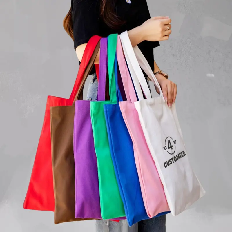 Woman holding multiple colorful customizable tote bags in various shades