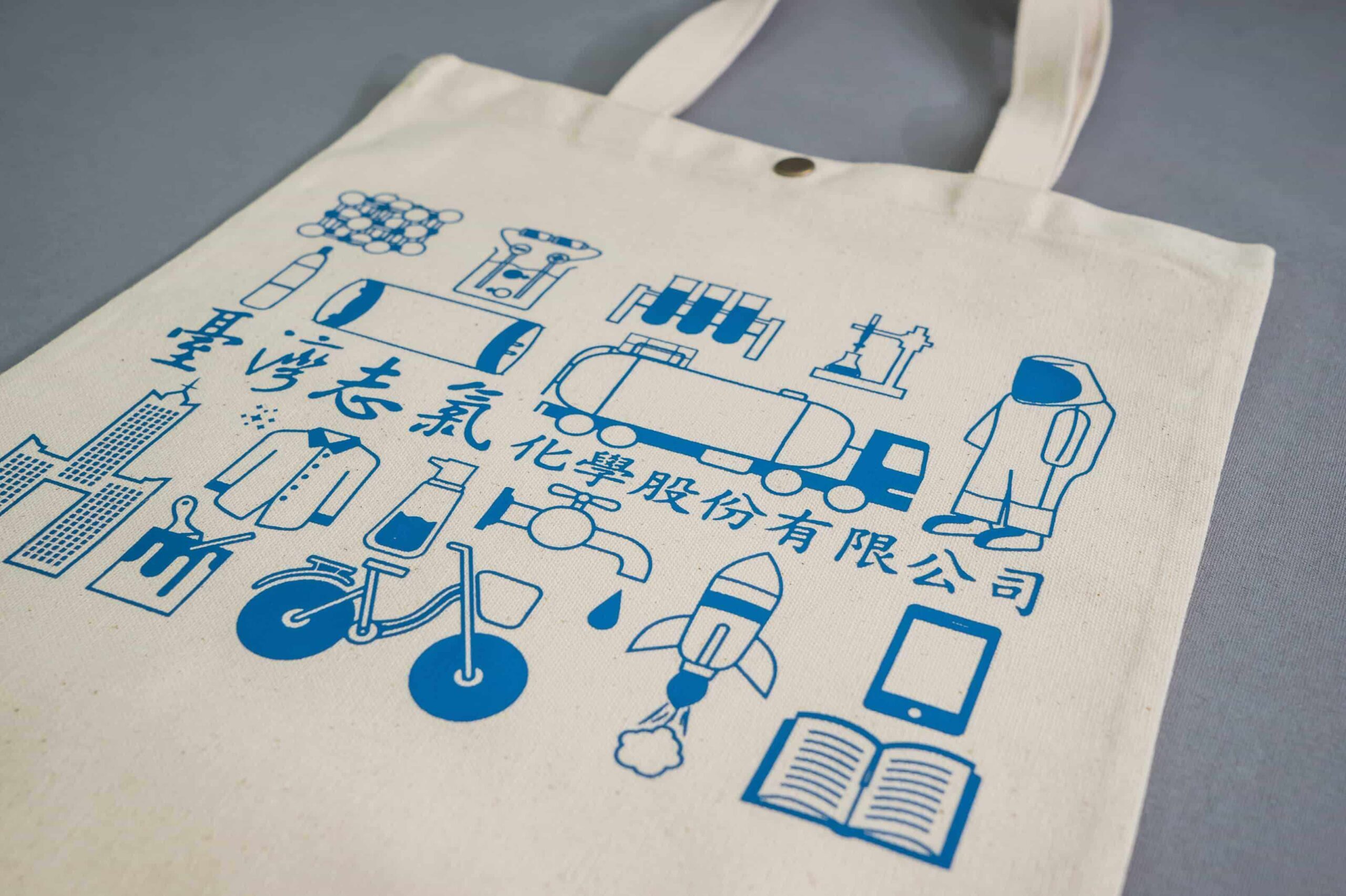 Eco-friendly tote bag with blue screen-printed scientific icons