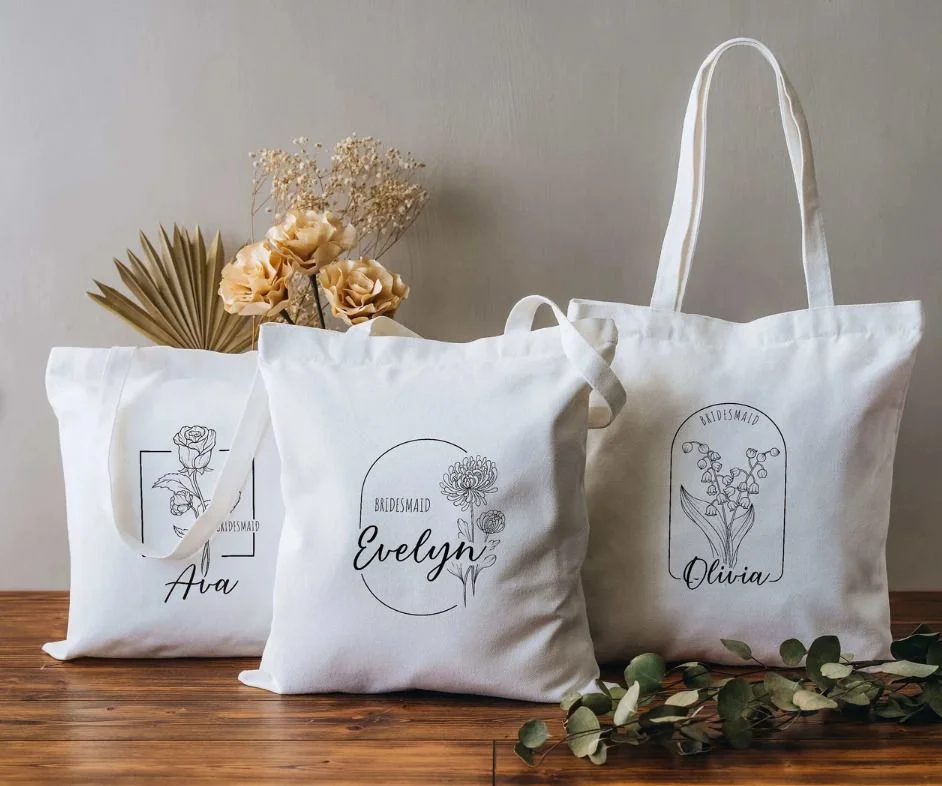 Personalized white bridesmaid tote bags with floral designs
