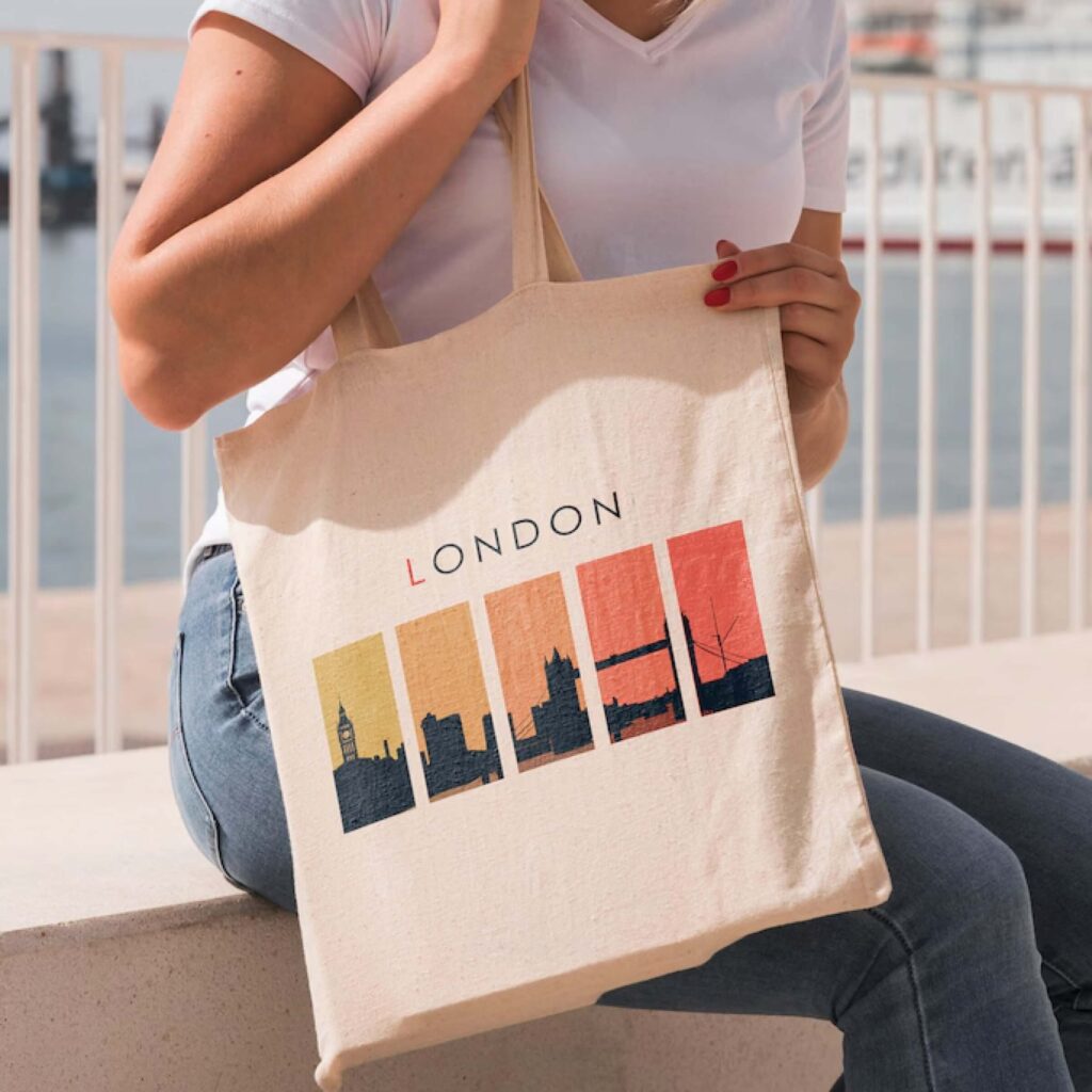 Woman holding London skyline printed canvas tote bag