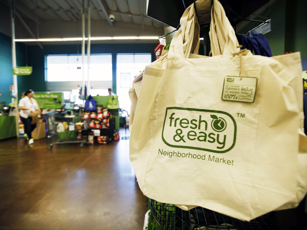 Reusable canvas tote bag with Fresh & Easy logo in supermarket