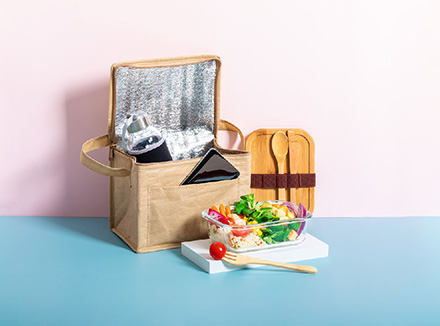 Brown aluminum foil insulated lunch bag with food and utensils