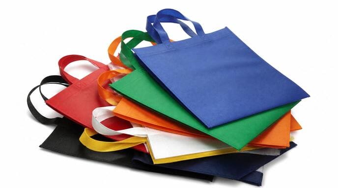 Pile of PP non woven shopping bags, showcasing their common appearance Pile of PP non woven shopping bags, showcasing their common appearance
